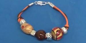 Cómo hacer una pulsera de dos hilos con objetos decorativos